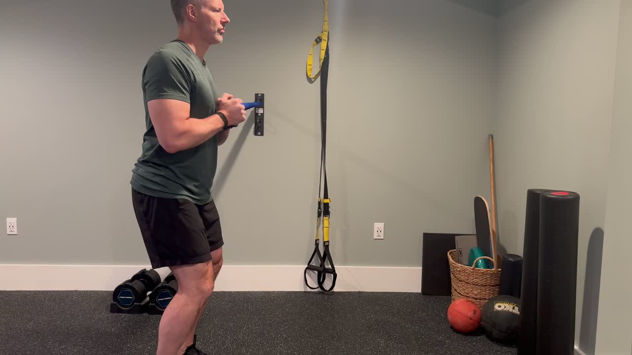 Brandon Kolar coaching a standing anti-rotation core exercise