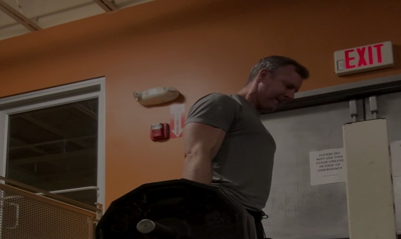 Brandon Kolar performing a cable machine exercise in the gym